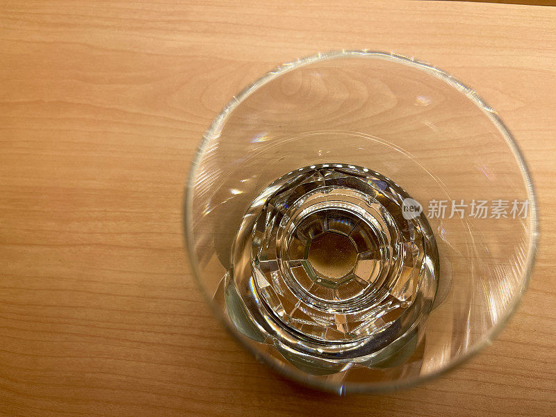 Top view of empty whiskey glass on wooden table